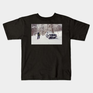 Tourist walking alone through winter forest passing off-road parked car Kids T-Shirt